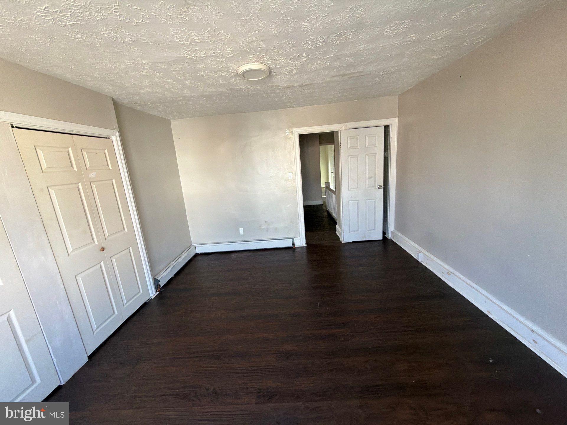 5540 Crowson Street Philadelphia, PA 19144 - Photo 9 of 11 an empty room with wooden floor and windows