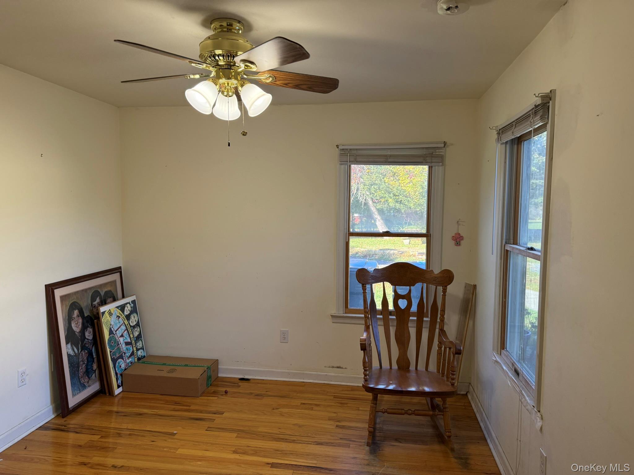 11005 Main Road East Marion, NY 11939 - Photo 11 of 26 a view of a livingroom with wooden floor and a chandelier