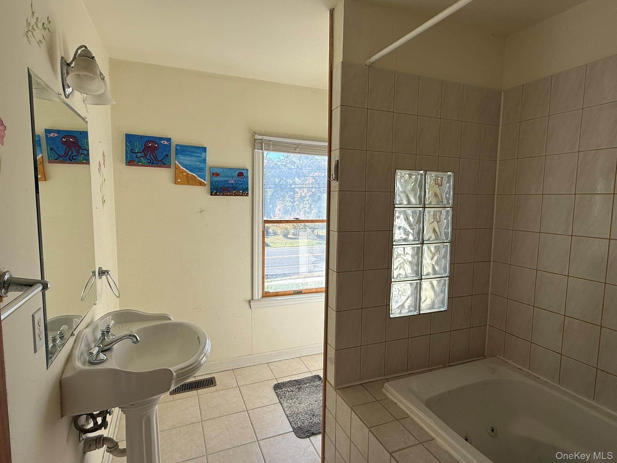 11005 Main Road East Marion, NY 11939 - Photo 13 of 26 a bathroom with a tub sink and mirror