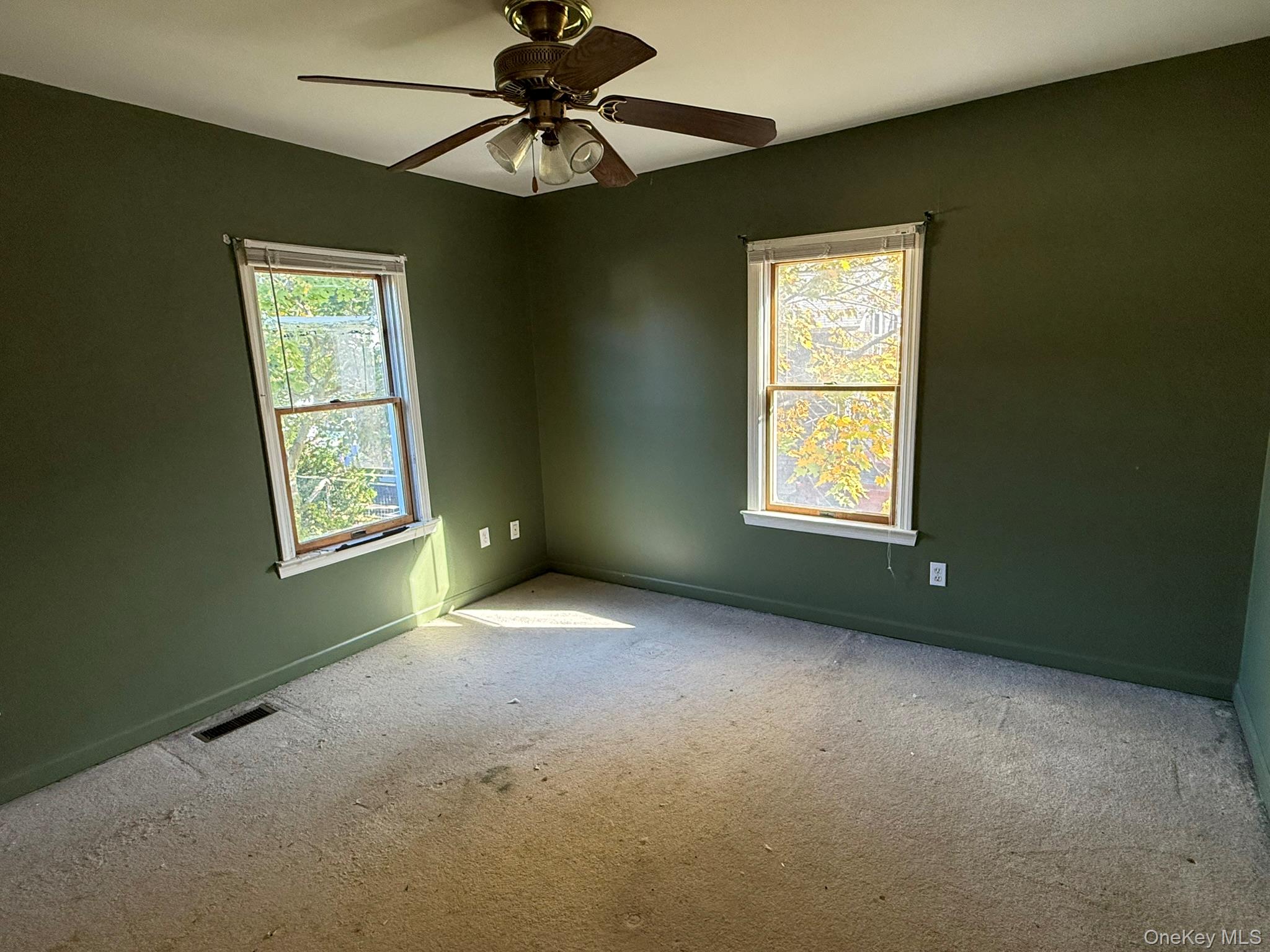 11005 Main Road East Marion, NY 11939 - Photo 16 of 26 an empty room with windows and fan