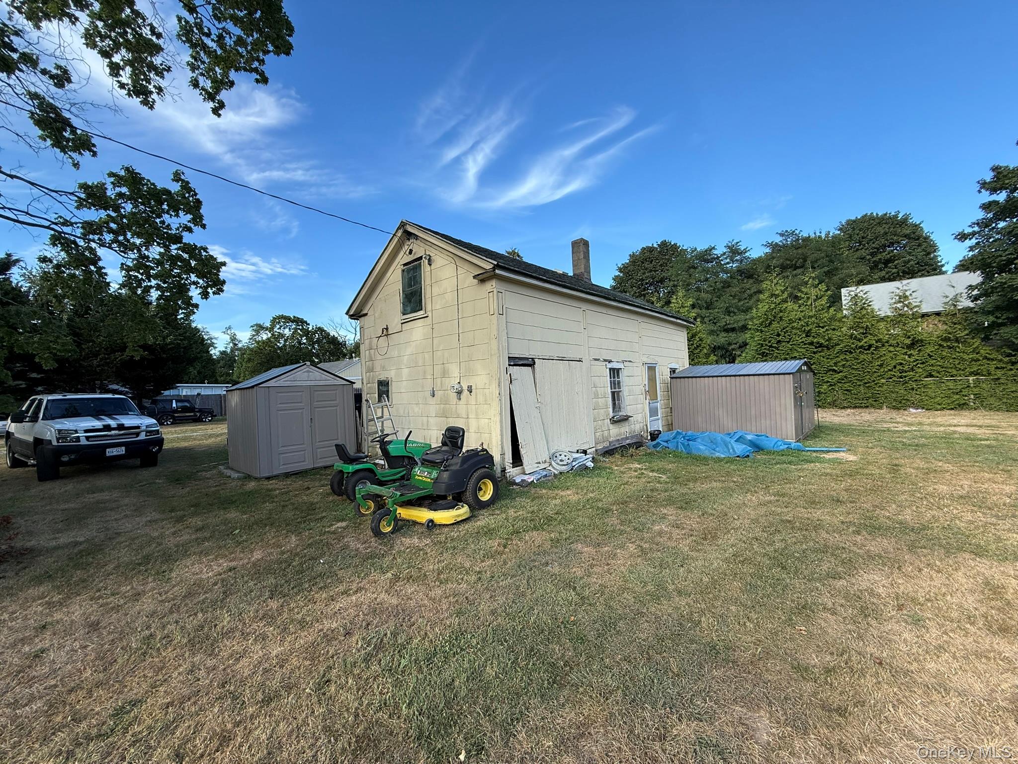 11005 Main Road East Marion, NY 11939 - Photo 17 of 26 a view of backyard with a car parked