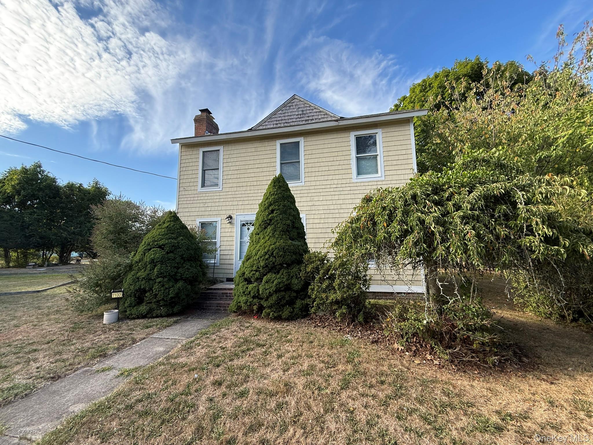 11005 Main Road East Marion, NY 11939 - Photo 2 of 26 a view of a house with a yard and plants
