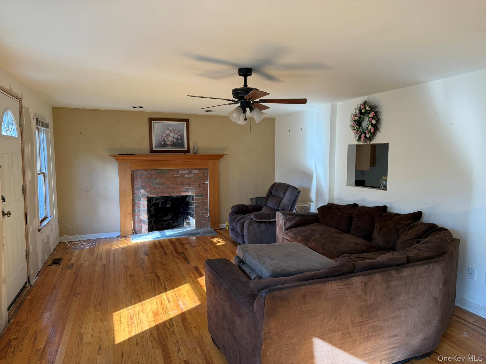 11005 Main Road East Marion, NY 11939 - Photo 6 of 26 a living room with furniture and a fireplace