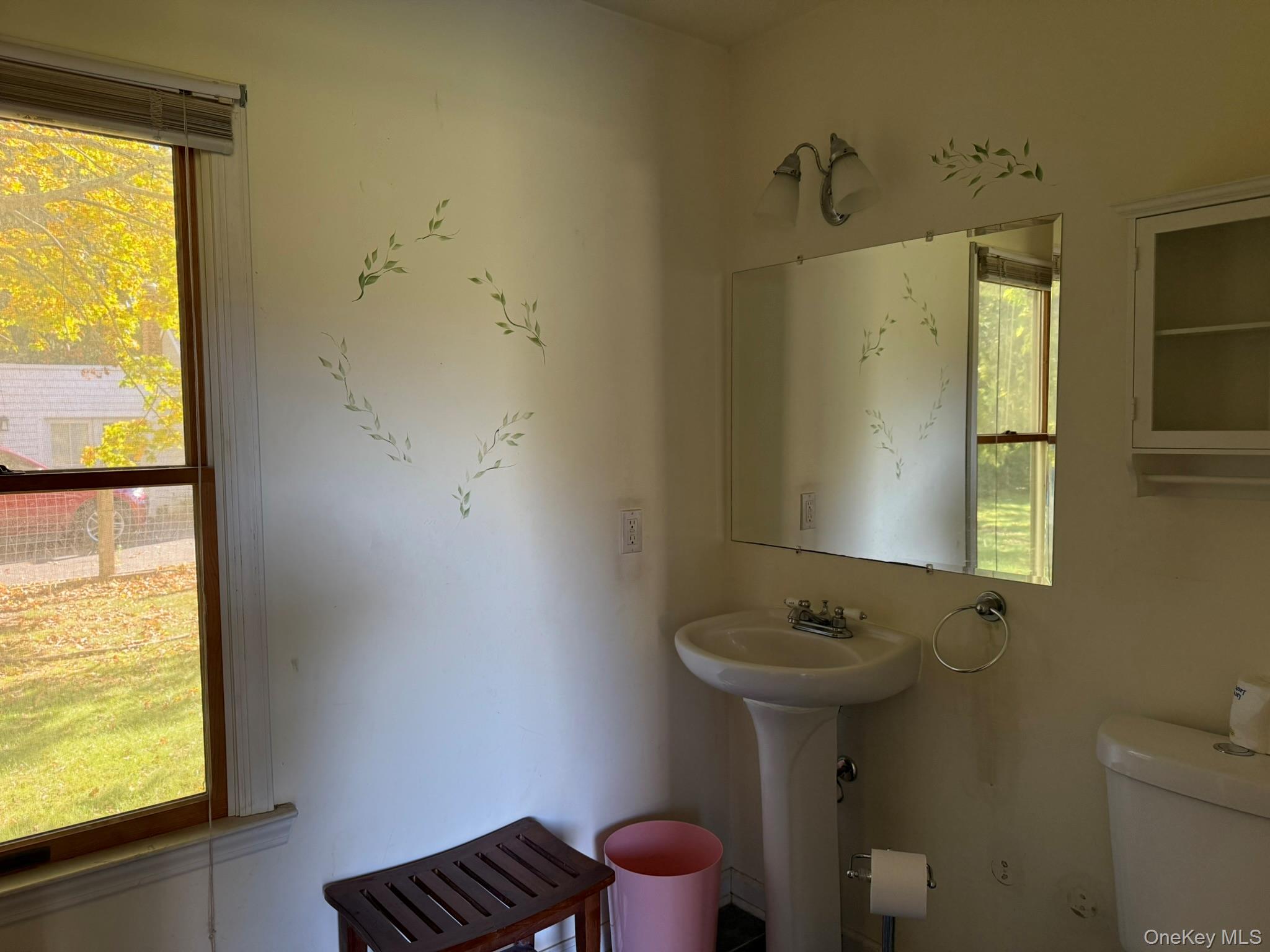 11005 Main Road East Marion, NY 11939 - Photo 10 of 26 a bathroom with a sink toilet and a mirror