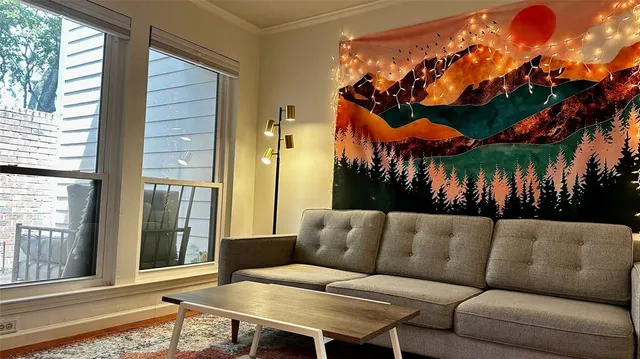 a view of a patio with couches and table and chairs with wooden floor