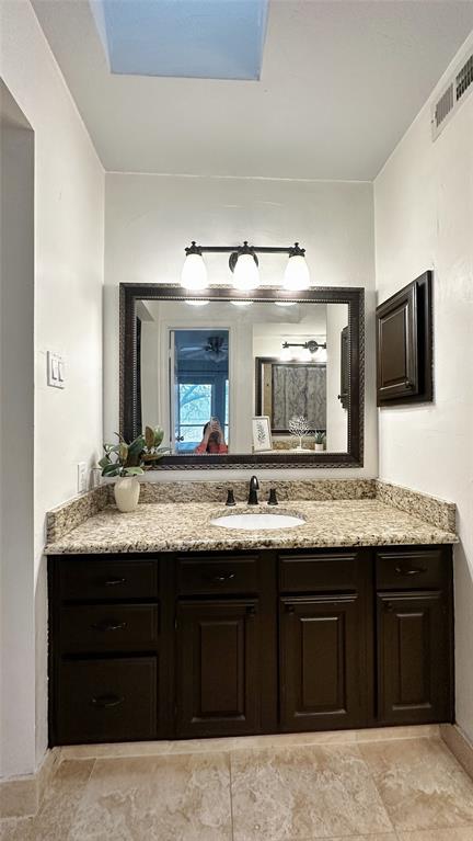 18240 Midway Road, Unit 104 Dallas, TX 75287 - Photo 14 of 22 a bathroom with a granite countertop double sink and a large mirror