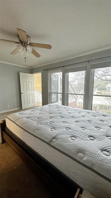 18240 Midway Road, Unit 104 Dallas, TX 75287 - Photo 15 of 22 a bed sitting in a spacious bedroom next to a window