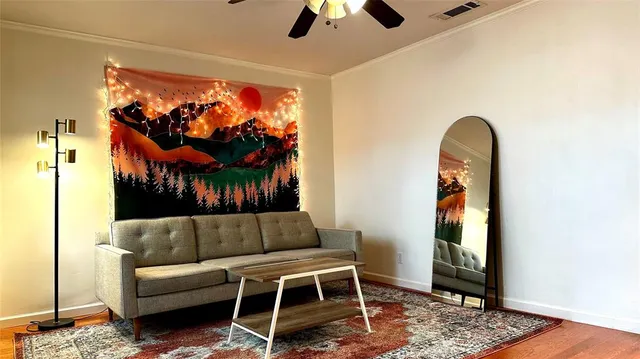 a living room with furniture a rug and a window