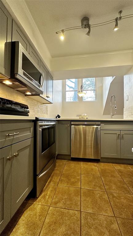 18240 Midway Road, Unit 104 Dallas, TX 75287 - Photo 9 of 22 a kitchen with stainless steel appliances granite countertop a sink and cabinets