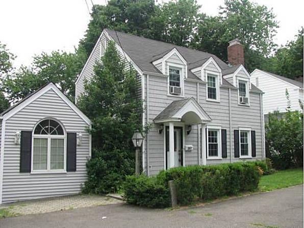 247 Glenbrook Road Stamford, CT 06906 - Photo 1 of 1 a view of a white house with large windows and a small yard