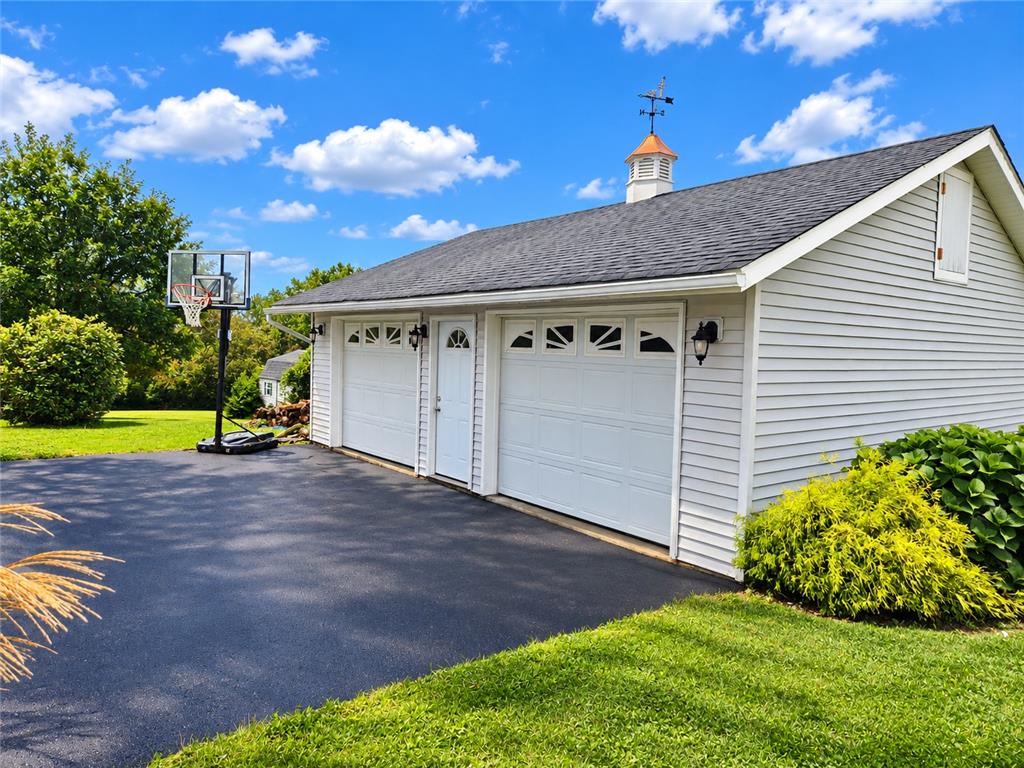 1480 Teels Road Pen Argyl, PA 18072 - Photo 4 of 18 A spacious detached garage features a paved driveway under clear blue skies.
