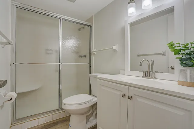 a bathroom with a sink toilet and shower