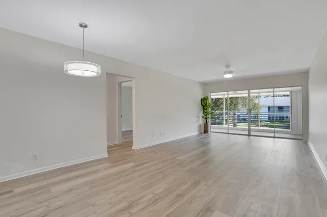 a view of a room with wooden floor and outdoor view
