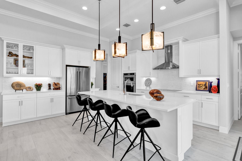 5594 Bent Pine Square Vero Beach, FL 32967 - Photo 12 of 35 a kitchen with a white cabinets and white appliances