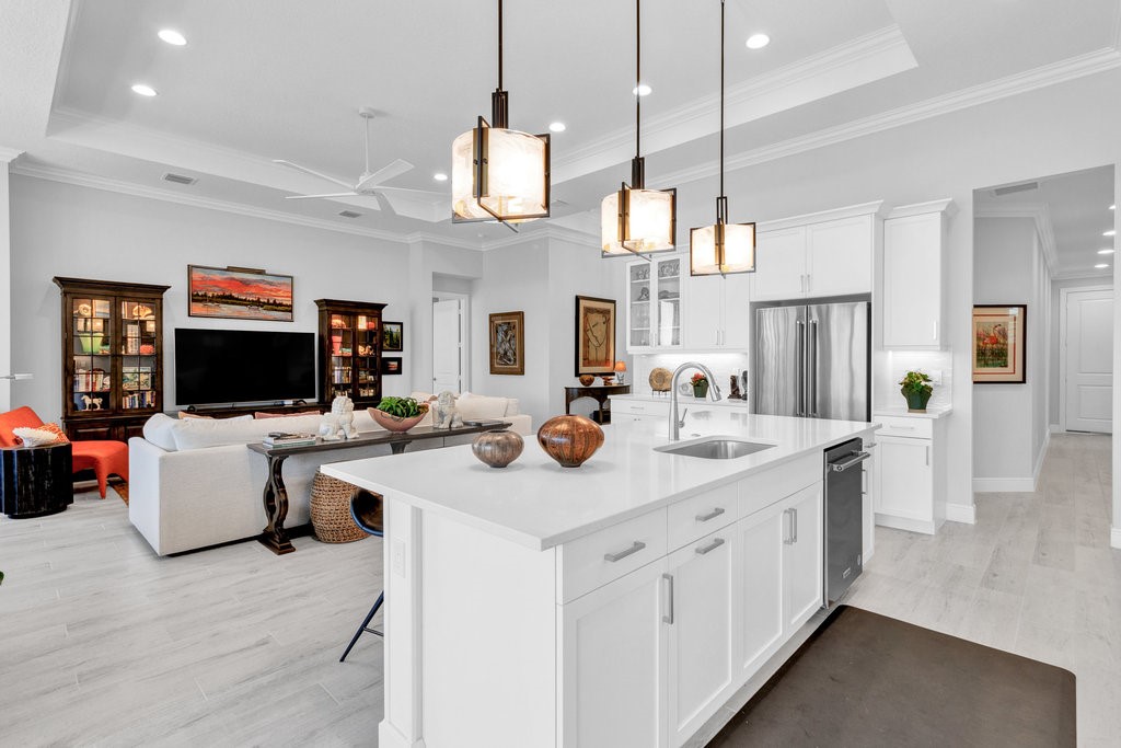 5594 Bent Pine Square Vero Beach, FL 32967 - Photo 14 of 35 a kitchen with a sink and living room view