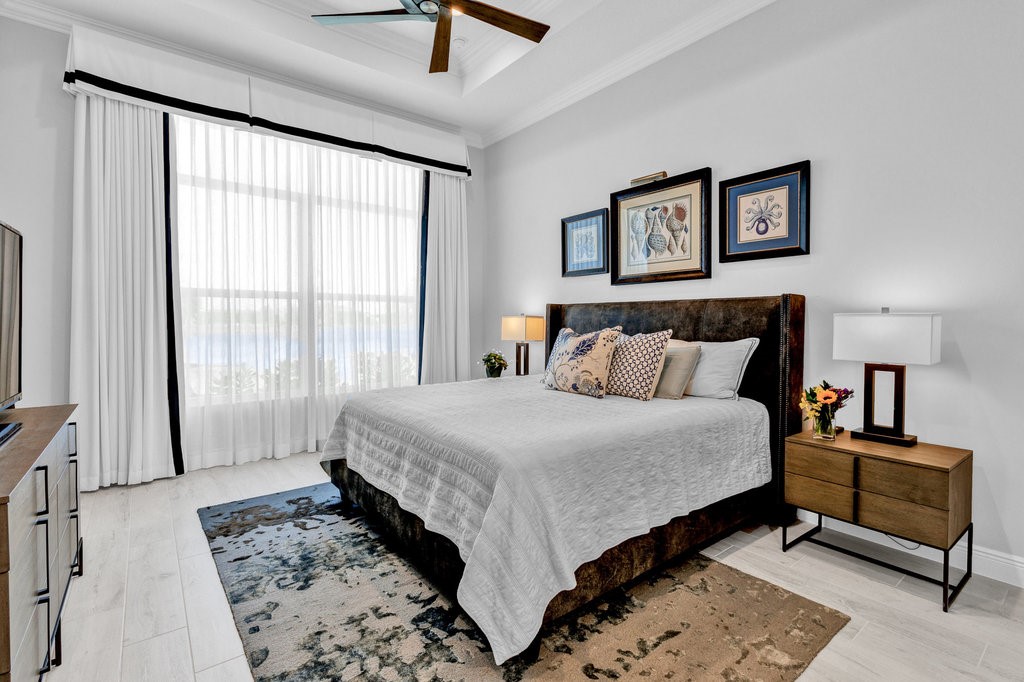 5594 Bent Pine Square Vero Beach, FL 32967 - Photo 16 of 35 a bedroom with a bed and a large mirror on the dresser