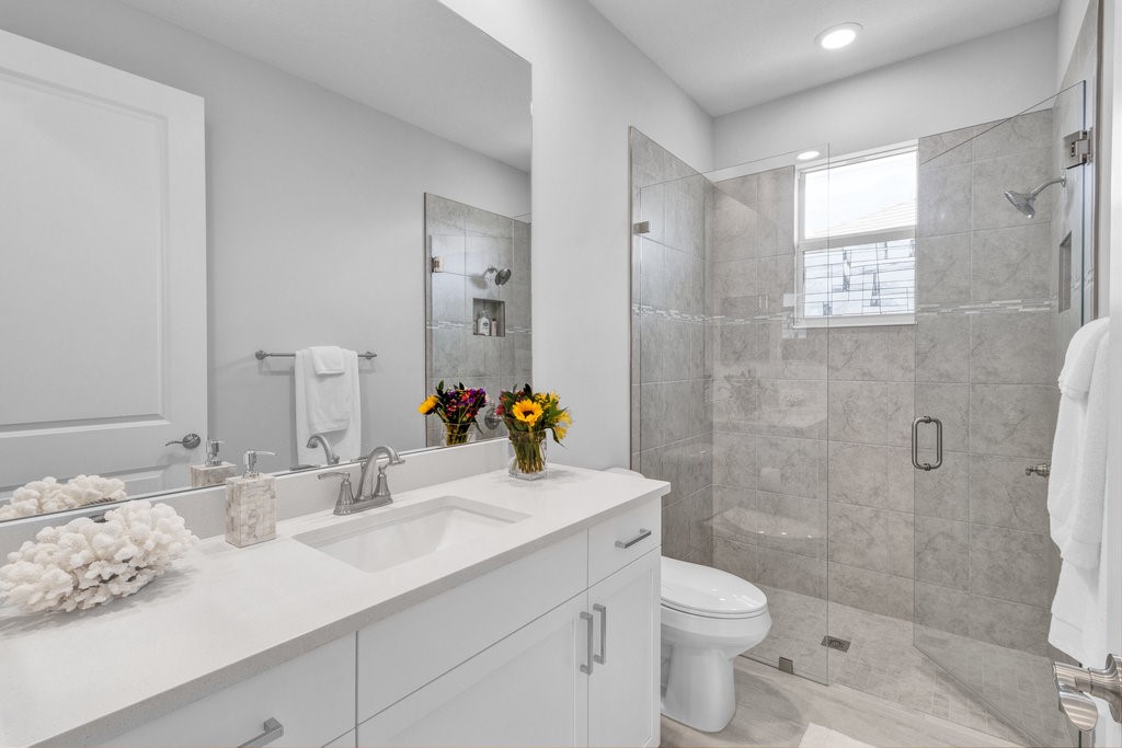 5594 Bent Pine Square Vero Beach, FL 32967 - Photo 22 of 35 a bathroom with a sink toilet and shower