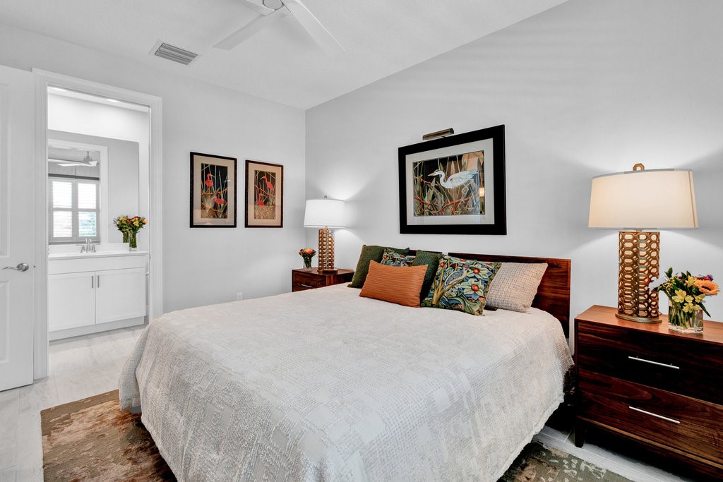 5594 Bent Pine Square Vero Beach, FL 32967 - Photo 24 of 35 a bed room with a bed and a lamp