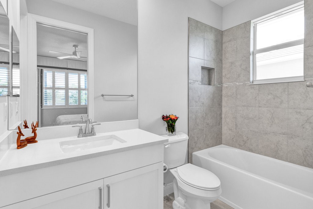 5594 Bent Pine Square Vero Beach, FL 32967 - Photo 25 of 35 a bathroom with a sink toilet vanity and tub