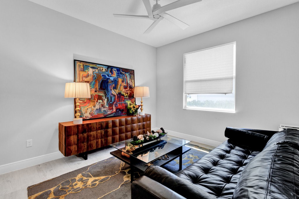 5594 Bent Pine Square Vero Beach, FL 32967 - Photo 26 of 35 a living room with furniture a couch and a window
