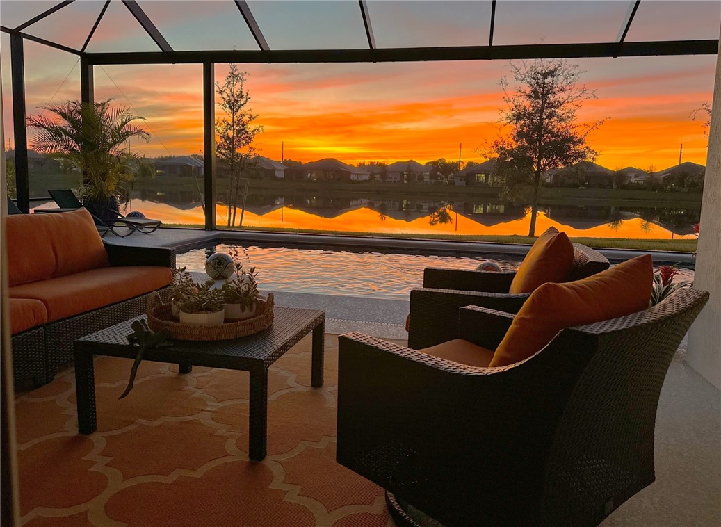 5594 Bent Pine Square Vero Beach, FL 32967 - Photo 34 of 35 a living room with a couch and a floor to ceiling window
