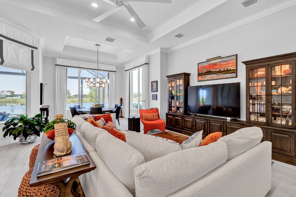5594 Bent Pine Square Vero Beach, FL 32967 - Photo 7 of 35 a living room with furniture flat screen tv and a large window