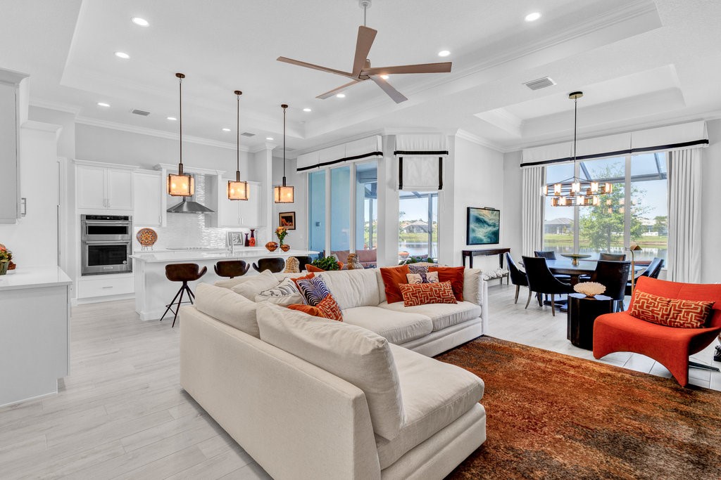5594 Bent Pine Square Vero Beach, FL 32967 - Photo 9 of 35 a living room with furniture kitchen area and a large window