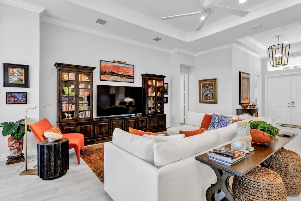 5594 Bent Pine Square Vero Beach, FL 32967 - Photo 10 of 35 a living room with furniture fireplace and a flat screen tv
