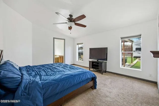 a bedroom with a bed and a television