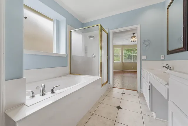 a bathroom with a bathtub sink and mirror