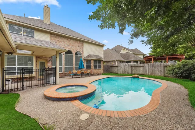 swimming pool view with a garden space