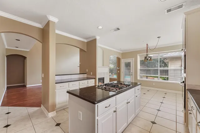 a kitchen with granite countertop a stove and a sink