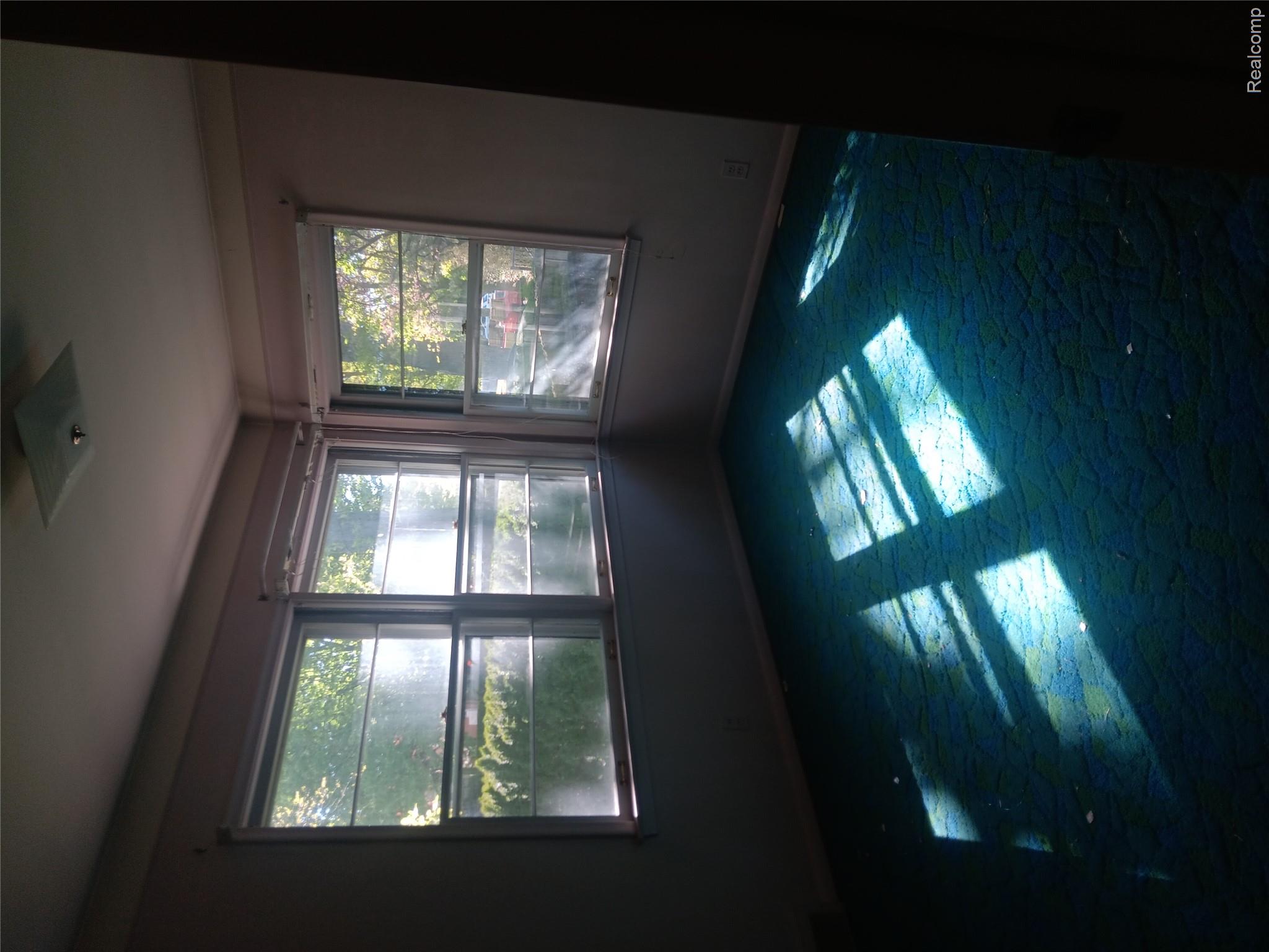 967 Washington Road Grosse Pointe, MI 48230 - Photo 10 of 15 Unfurnished room with plenty of natural light and dark colored carpet