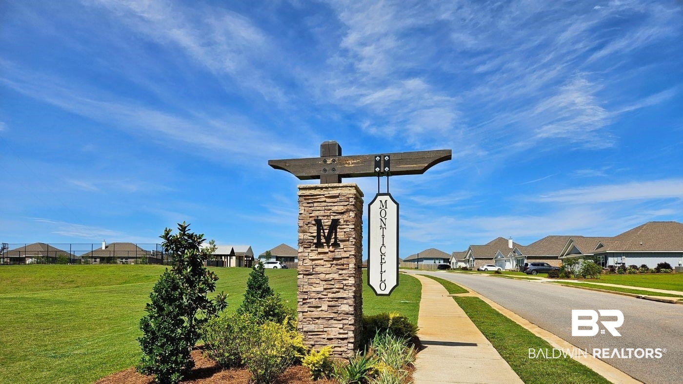 32125 Lyon Road Daphne, AL 36527 - Photo 68 of 70 Stone and timber community entrance sign with a manicured shrub and tree landscape