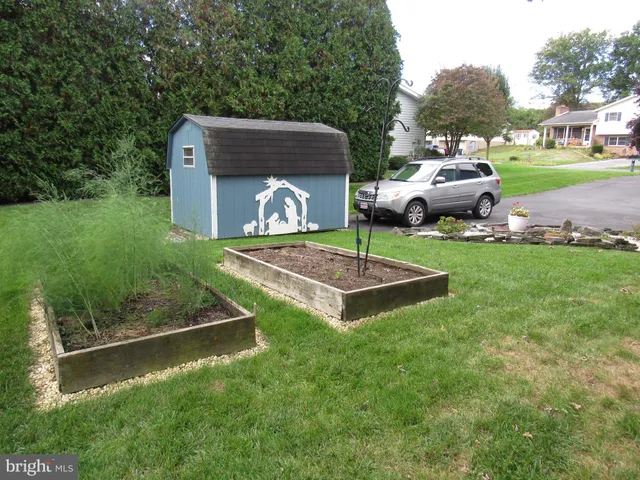 a view of a backyard with sitting area