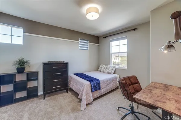 a bedroom with a bed and window