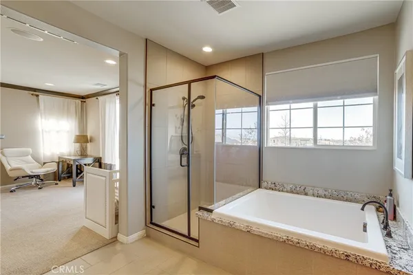 a bathroom with a tub and a shower