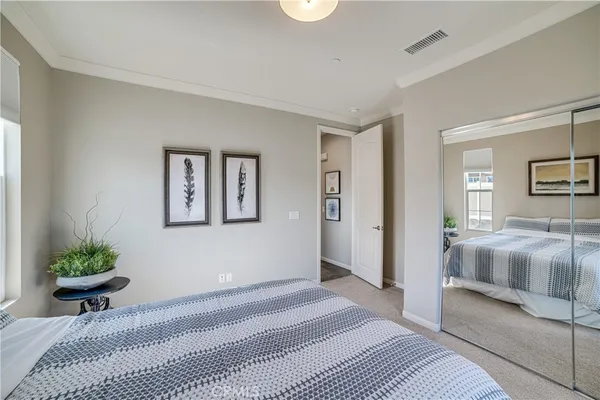 a bedroom with a bed and a couch