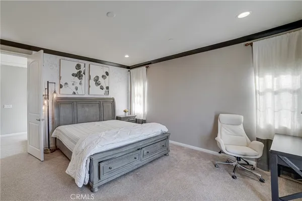 a bedroom with a bed and chair