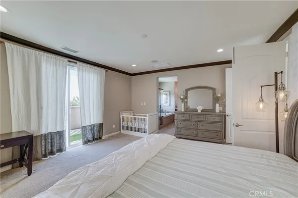 a room with a bed and a dresser