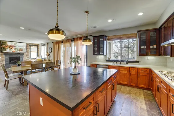 a kitchen with stainless steel appliances granite countertop a sink a stove and a center island