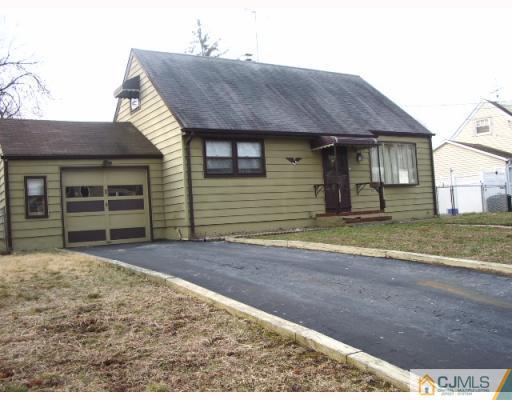 21 Wilcox Road New Brunswick, NJ 08901 - Photo 1 of 10 a front view of a house with a yard and garage
