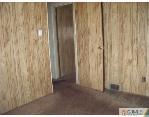 21 Wilcox Road New Brunswick, NJ 08901 - Photo 6 of 10 a view of an empty room with a wooden door