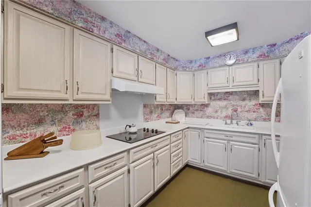 a kitchen with stainless steel appliances granite countertop a sink stove and cabinets