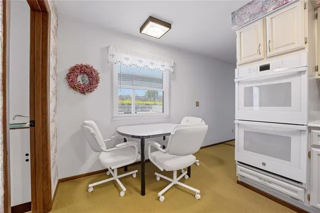 a dining room with furniture and a window