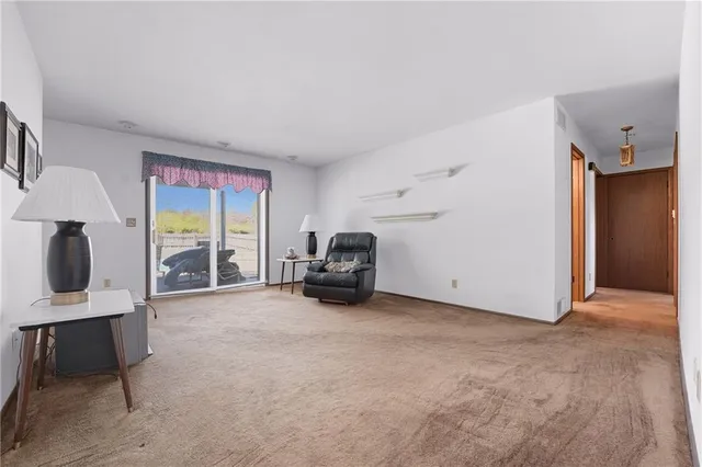 a view of a livingroom with furniture and a ceiling fan