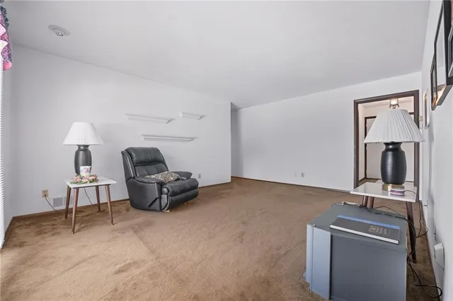 a living room with furniture and a mirror