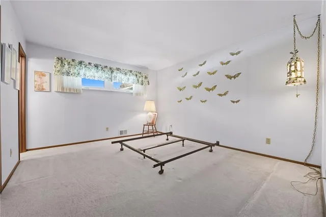 a room with window and white walls