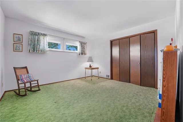 a bedroom with a bed and chair