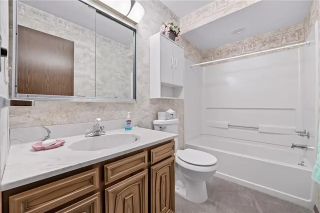 a bathroom with a sink a toilet and a bathtub